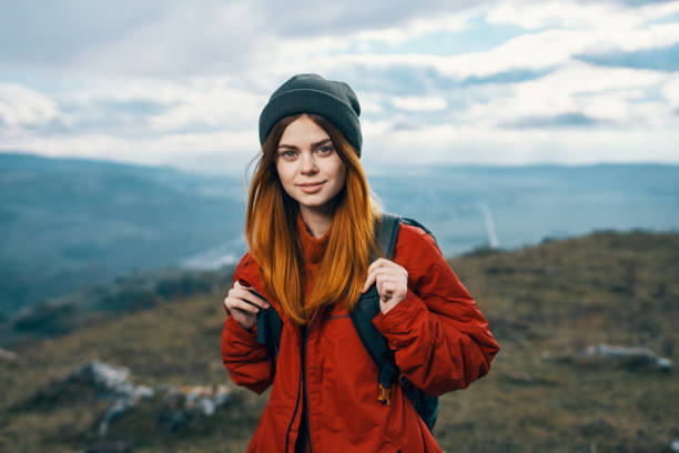 young traveler with backpack and mountains in the background landscape sky clouds. High quality photo