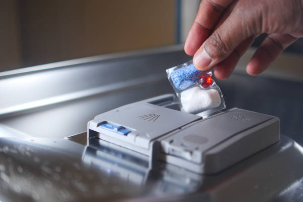 istock The person is using a soap dispenser for the dishwasher with their hand 2153118476