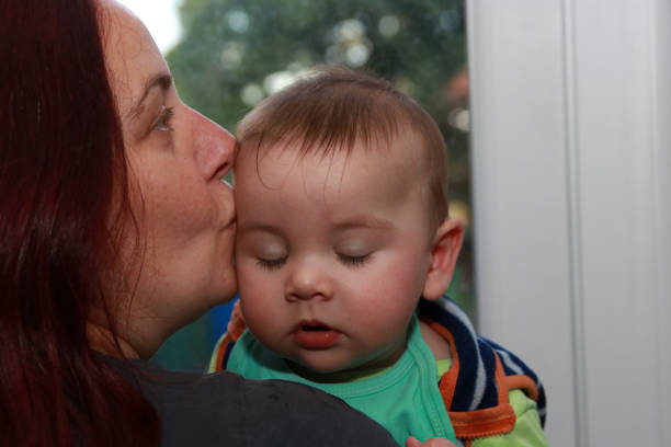 hug baby mother boy red head hair kiss