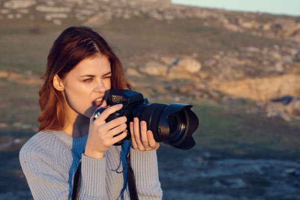 istock cheerful woman photographer outdoors nature work lifestyle 2153123790