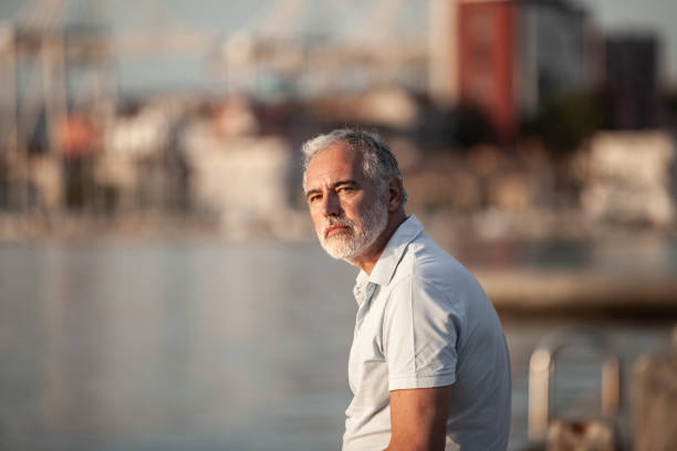 istock Pensive man distancing himself from society and  looking at sunset 2153130606
