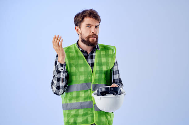 male worker in a white helmet blueprints Professional isolated background. High quality photo