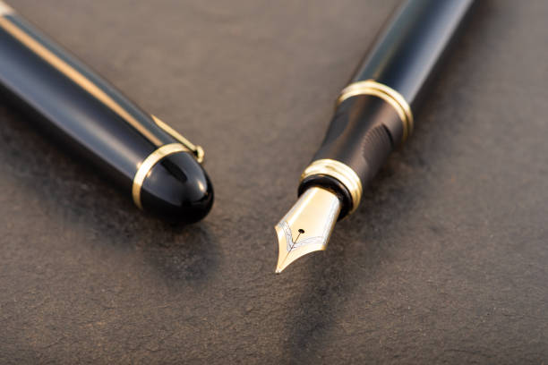 istock Black fountain pen on stone surface, selective focus 2153132517