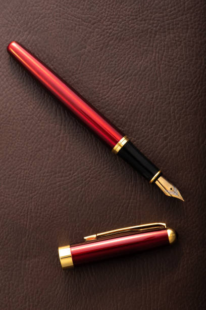 istock Red fountain pen on leather surface, selective focus 2153132526