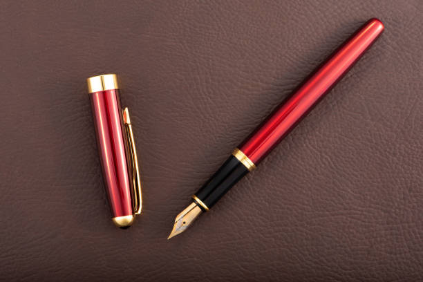 istock Red fountain pen on leather surface, selective focus 2153132541