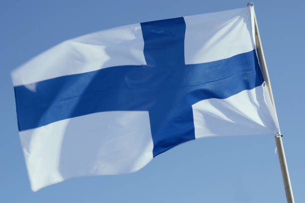 istock Finnish Flag Waving Against Clear Blue Sky 2153132863