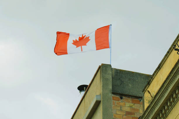 istock Canadian Flag Flying Atop Building 2153132867