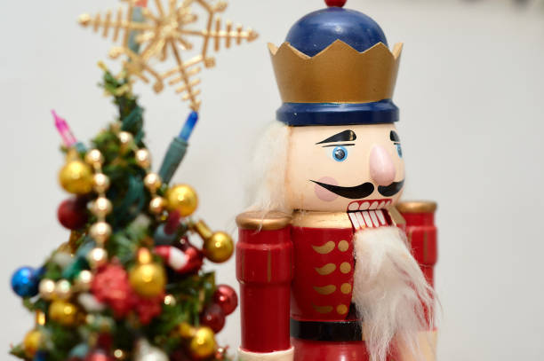 istock nut cracker christmass decorative doll on the table next to a small christmass tree 2153134599