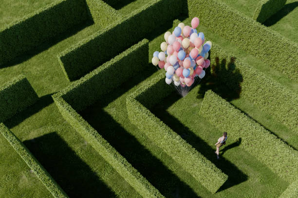 istock Woman standing in hedge maze 2153136610