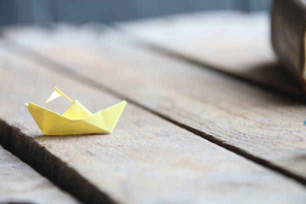istock Back to school idea. Paper ship and book 2153137360