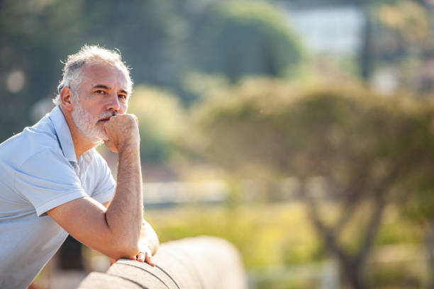 Pensive alone mature man looking at view