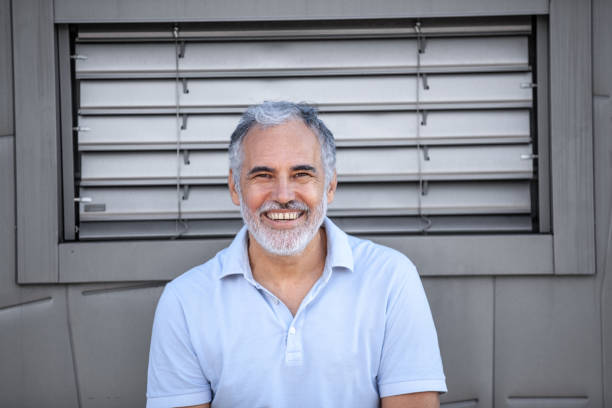 istock Serene mature man portrait against metallic grey wall 2153141472