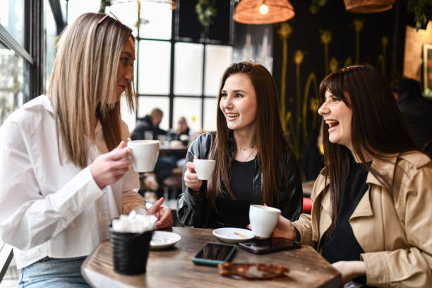 istock Cute Female Friends Sharing Laughs And Talks During Coffee Time 2153142235