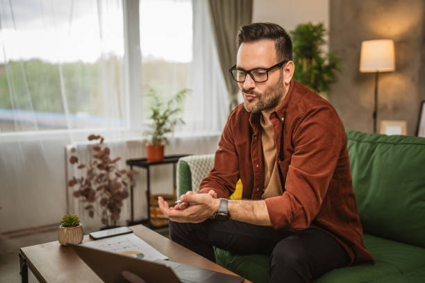 istock Adult caucasian man work from home on laptop and hold documents 2153147939