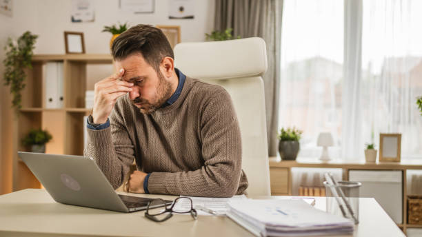 istock Exhausted adult caucasian man have eyestrain while work at office 2153148570