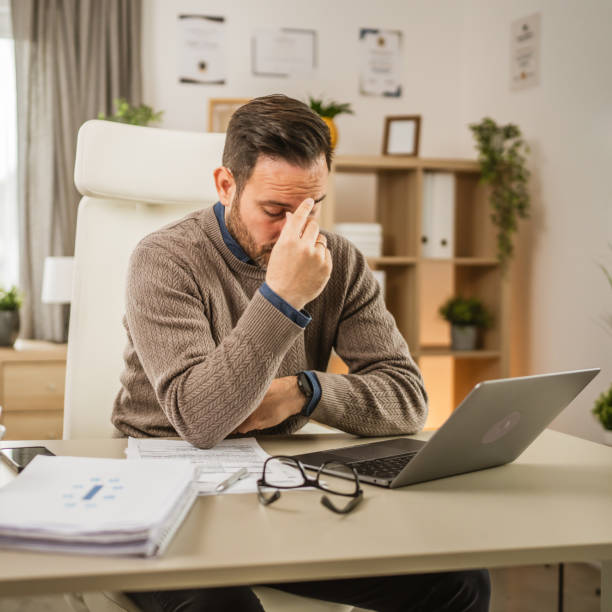 istock Exhausted adult caucasian man have eyestrain while work at office 2153148581