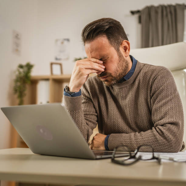 istock Exhausted adult caucasian man have eyestrain while work at office 2153148714