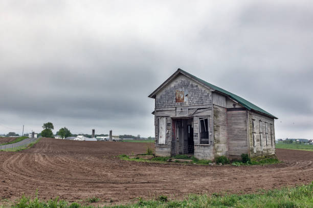 Abandon One Room Schoolhouse in the freshly tilled farm field.