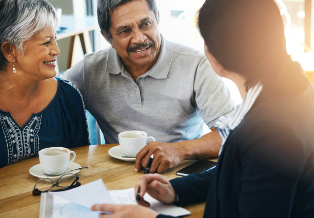 istock Senior couple, discussion and financial advisor with documents for retirement plan, budget advice and will at home. Old man, elderly woman and attorney with paperwork, negotiation and legal agreement 2153154024