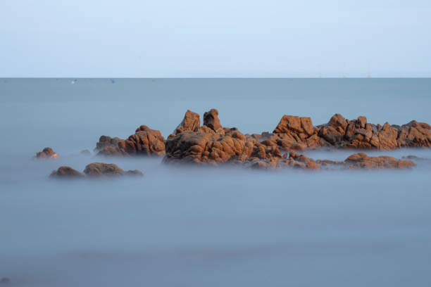 Long exposure of rocks on the coast in the evening