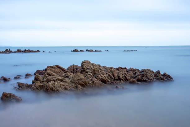 Long exposure of rocks on the coast in the evening
