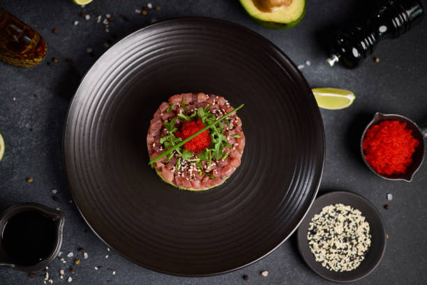 istock Tuna and avocado tartare on a dark ceramic plate 2153155989