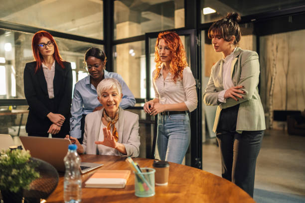 istock Diverse female team collaborating and discussing project at office. 2153156131