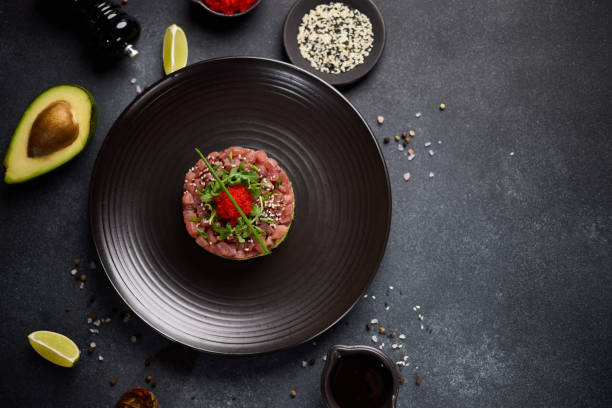 istock Tuna and avocado tartare on a dark ceramic plate 2153156250