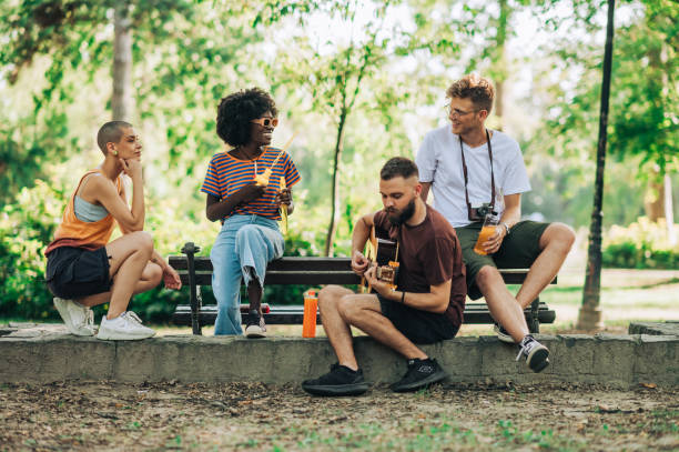 istock Group of multicultural hippie friends having jam session in park. 2153156283