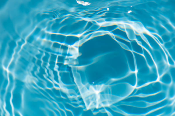 istock Bluewater waves on the surface ripples blurred. Defocus blurred transparent blue colored clear calm water surface texture with splash and bubbles. Water waves with shining pattern texture background. 2153160201
