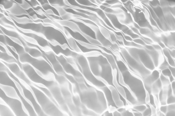 istock Bluewater waves on the surface ripples blurred. Defocus blurred transparent blue colored clear calm water surface texture with splash and bubbles. Water waves with shining pattern texture background. 2153160222