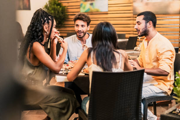 istock Multicultural Friends Dining at Restaurant - Enjoying Dinner Together 2153160413