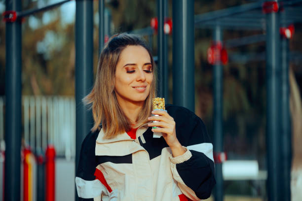 istock Happy Woman Eating a Cereal Bar After Working Out 2153160831