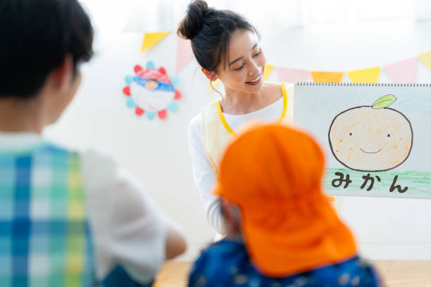 Nursery teacher reading a picture book