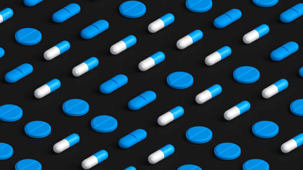 istock Many white blue capsules, tablets and pills on black background, tablet grid. Drug, tablet, pills top flat view. 3d render illustration 2153163483