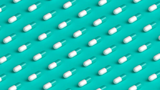 istock Many white turquoise capsules on turquoise background, tablet grid. Drug, tablet, pills top flat view. 3d render illustration 2153163538