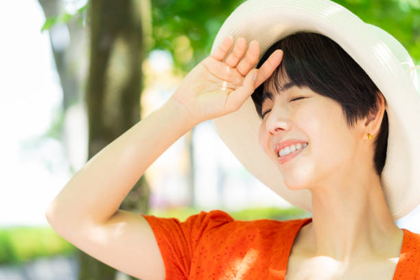 istock woman wearing a straw hat 2153163679