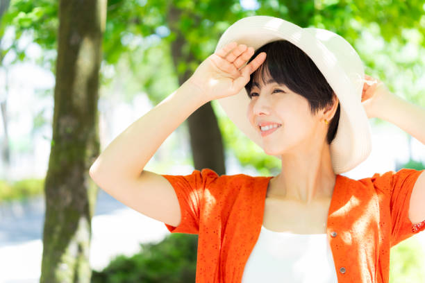 istock woman wearing a straw hat 2153163682