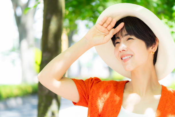 istock woman wearing a straw hat 2153163684