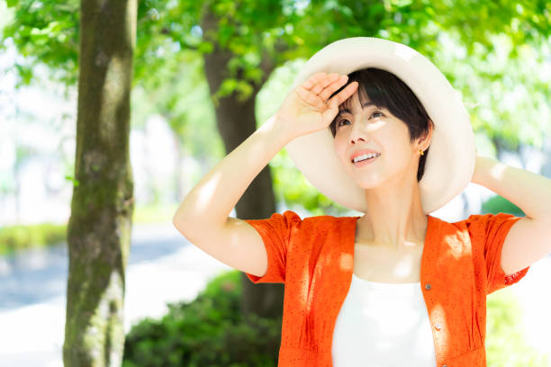 istock woman wearing a straw hat 2153163690