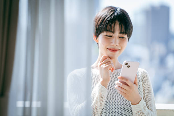 istock young woman with mobile phone 2153167410