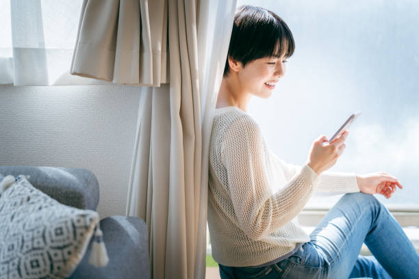 istock young woman with mobile phone 2153167439
