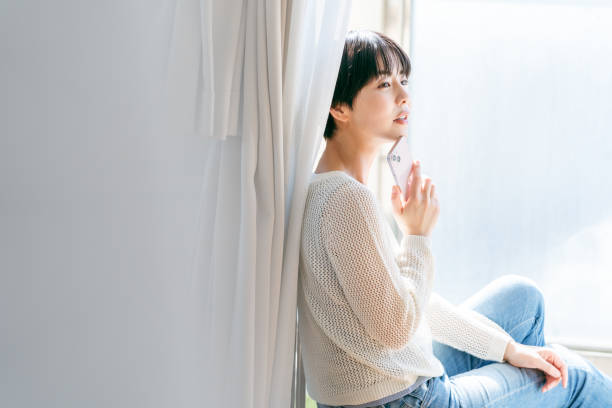 istock young woman with mobile phone 2153167443