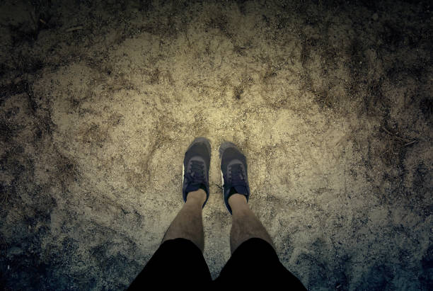 istock Man's feet in the sand 2153168101