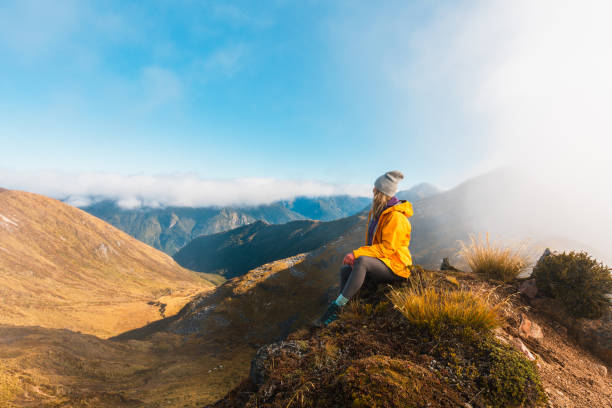 istock Female hiker relaxes on mountain ridge, 2153169110