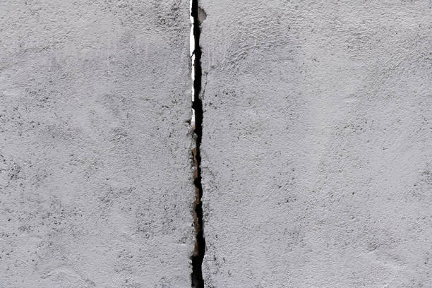 istock Gray concrete wall with crack 2153173299