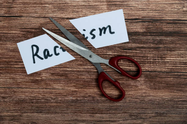 istock Scissor cutting paper with word racism 2153173538