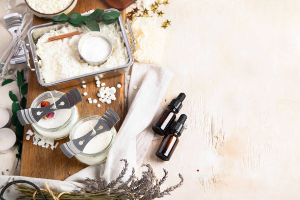 istock DIY. Crafting white aroma candles on light wood background. 2153173742