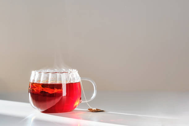 istock Glass mug with hot black tea on the table. 2153176218