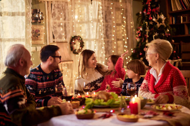 istock Cheerful extended family talking during Christmas dinner at home. 2153179140